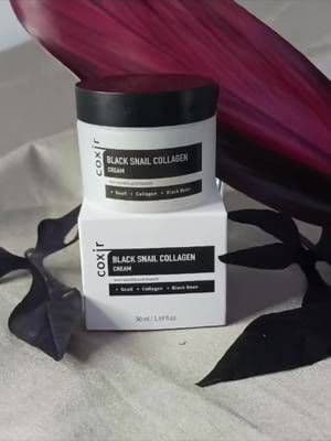 Are you in search of a deep moisturizing cream that repairs, nourishes, and diminishes fine lines and wrinkles all in one? Coxir Black Snail Collagen Cream is the answer to your skincare prayers. The consistency of this cream is unique . It has a slimy texture, so it's best to use it with the little spatula that comes with the product. Despite its composition, I was pleasantly surprised to find that it didn't leave my face feeling greasy or wet after rubbing it in. Instead, it left my skin feeling smooth, soft, and hydrated. While not a fan of the initial texture, I can't deny the amazing results this cream has on my skin. Give it a try and see for yourself! #stylevana #vanafamily #vanateam #SVBeautifulSelf #koreanskincare #kbeauty #koreanbeauty #skincarekorea #skincare #beauty #skin #skincareroutine #glowingskin #healthyskin #skincaretips #skincareproducts #honestreview #productreviewer #productreviews #myskincareroutine #coxir #blacksnailcollagencream #moisturizer #wrinkles #collagencream #collaboration #digitalcreator #lovemyproducts #lovemyskin #smoothskin